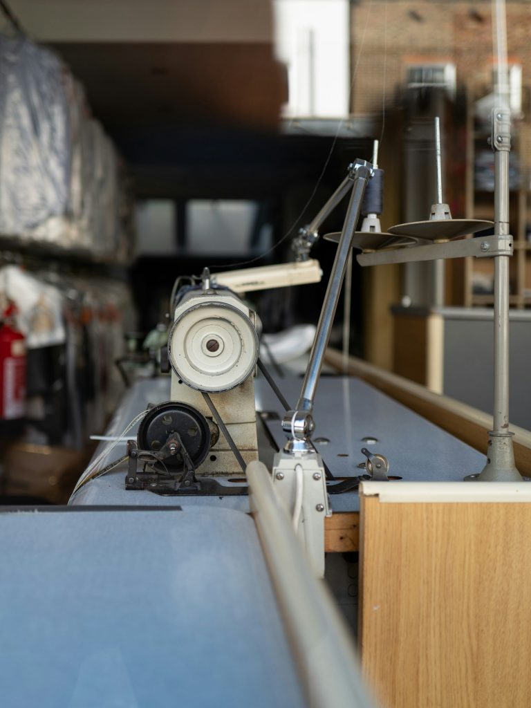 Industrial sewing machine setup in workshop.